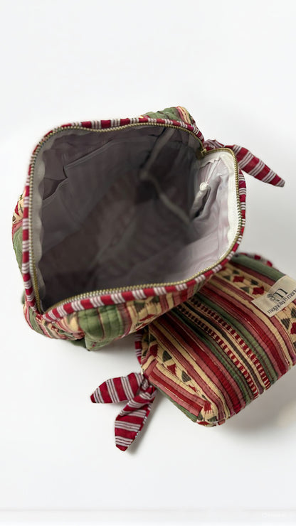 Decorative fabric pouch with a patterned design on a white background